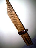 A Khene flute, part of a Sample Pack, delicately hanging on a wall.