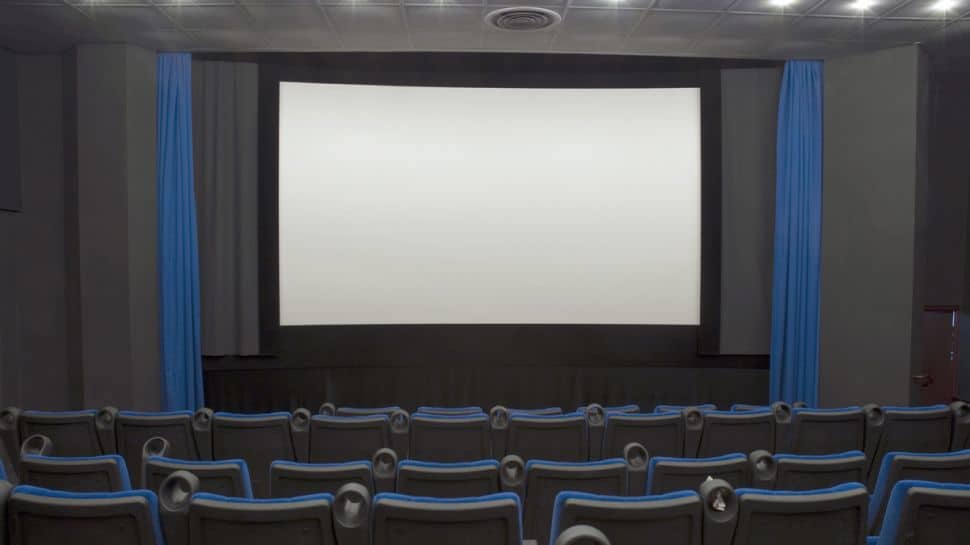 A cinematic theater with blue chairs and a large screen, setting the dramatic stage for captivating dramas.