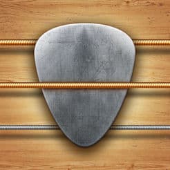 A guitar pick resting on a wooden background, ready for playing chords or picking out tabs on the guitar.