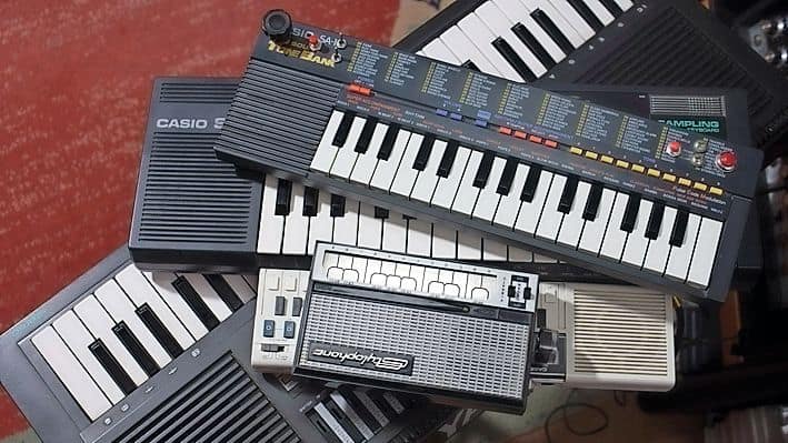 A group of cheap synths stacked on top of each other.