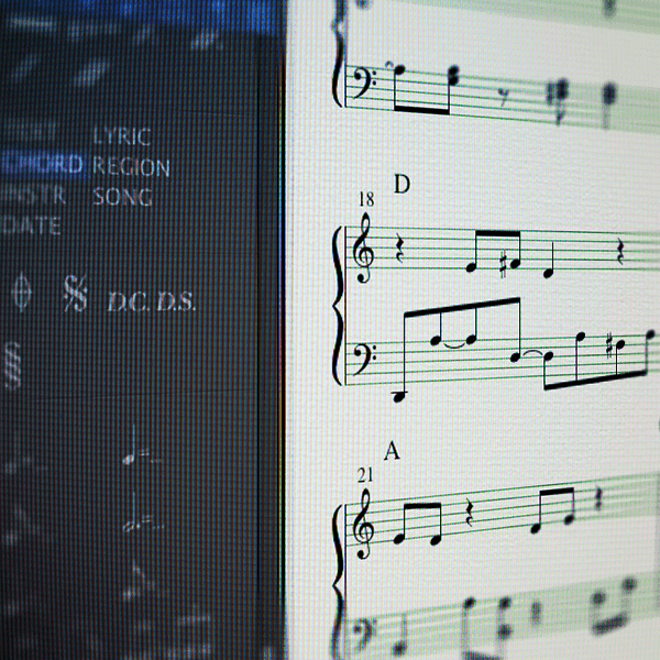 A sheet of music on a computer screen, featuring electronic producers.