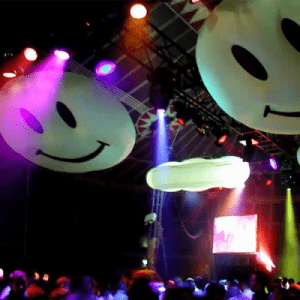 Smiley faces loops hanging from the ceiling at a party.