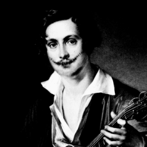 A man playing a guitar in a black and white photo.