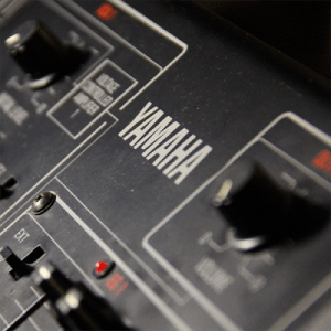 A close up of a Yamaha CS15 synthesizer.