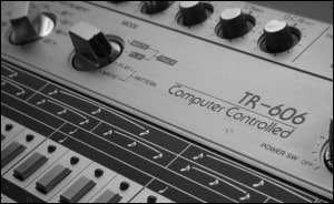 A black and white photo of a Roland synthesizer.