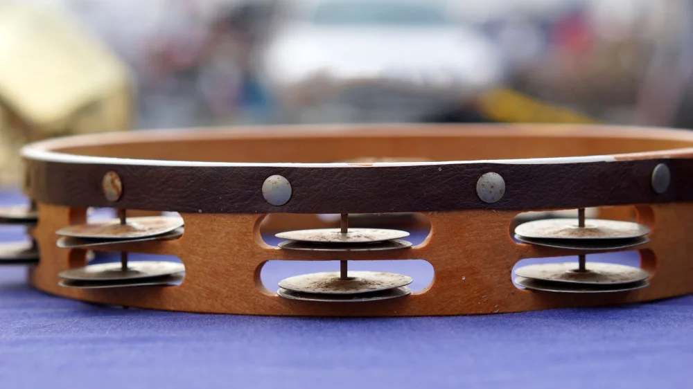 A leather belt embellished with buttons.