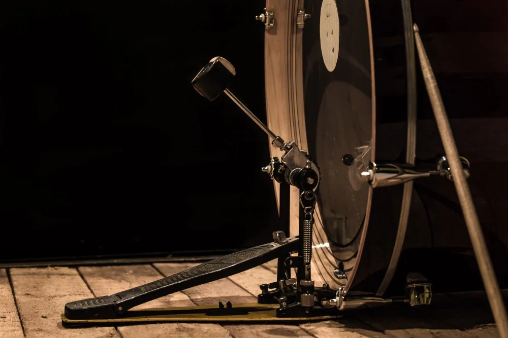 A drum set is sitting on a wooden floor, creating the perfect sound.