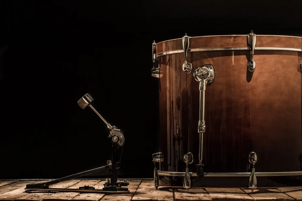 A drum sits on a wooden table against a black background in the Ultimate Guide to Perfect Sound.