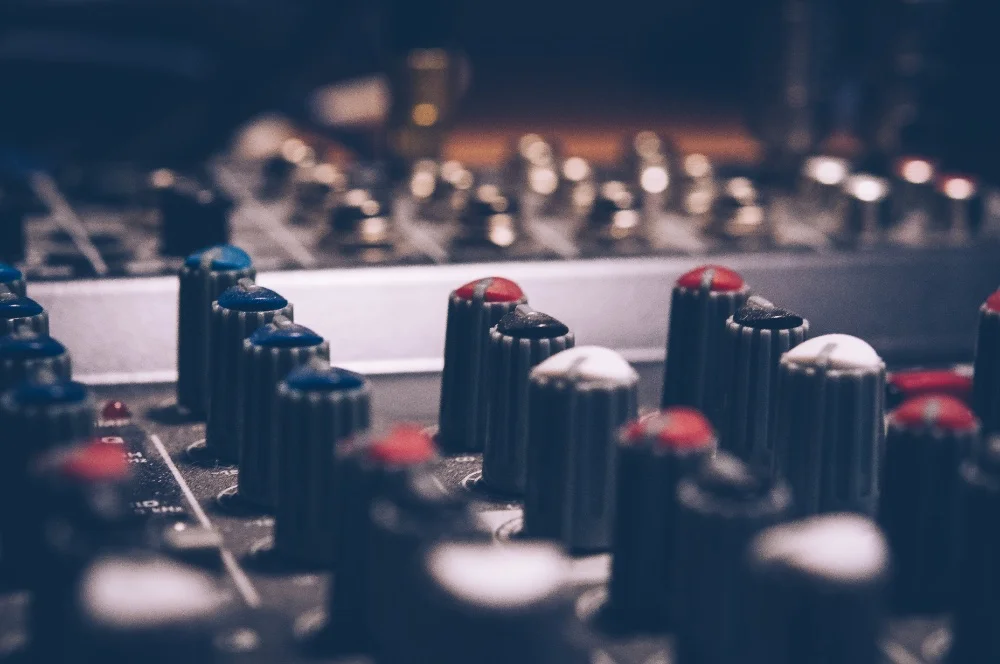 A close up of an audio mixing board designed to enhance audio quality.