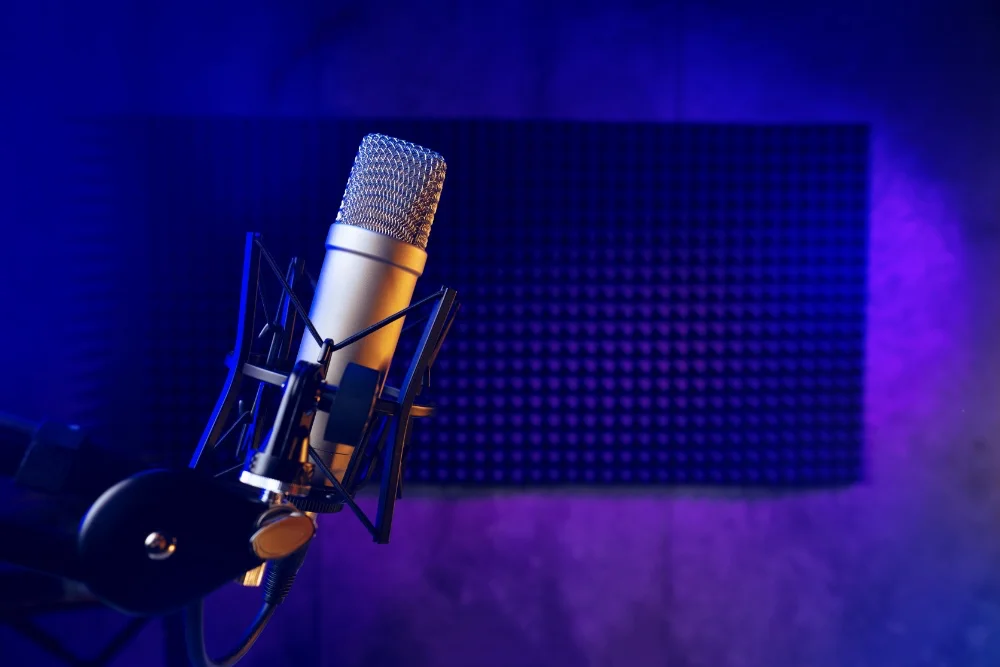 A microphone in a recording studio with blue lighting, capturing the perfect sound.
