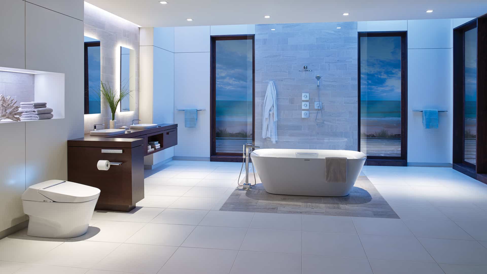 A modern bathroom with a bathtub, sink and toilet. The bathroom offers a minimalist design with sleek fixtures and contemporary amenities for optimum comfort.