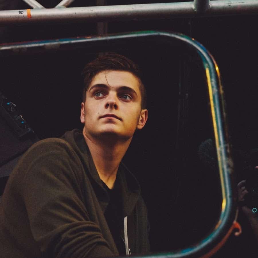 A young man looking out of a truck window.