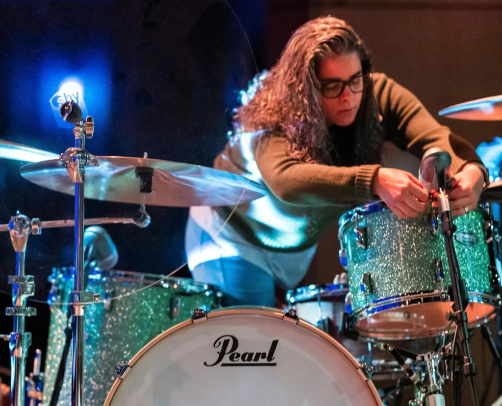 a woman positioning the microphone of the drum kits