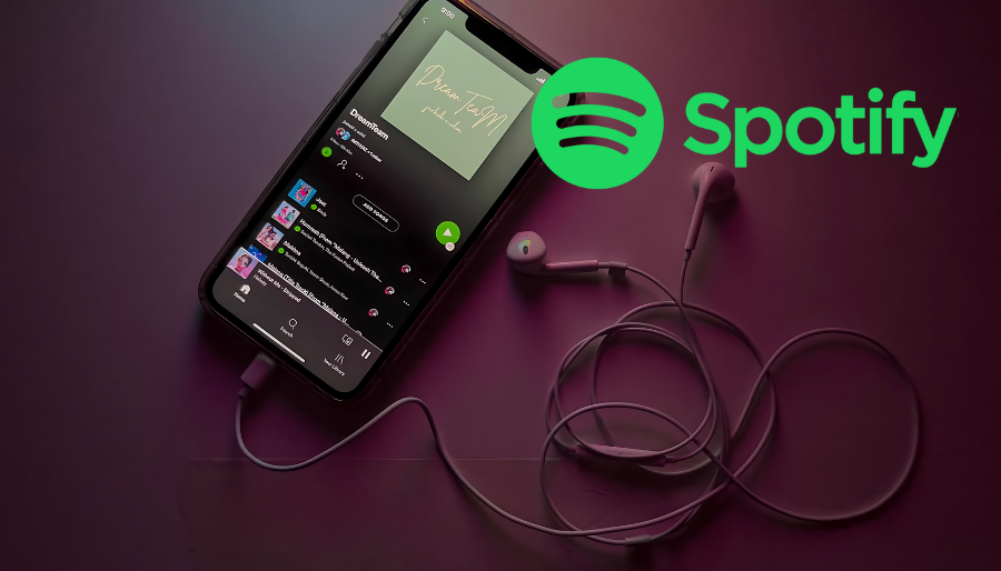 a cellphone with earbuds and a Spotify logo